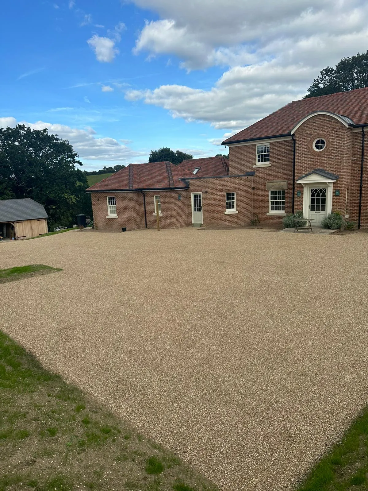A large brick building with a driveway in front of it.