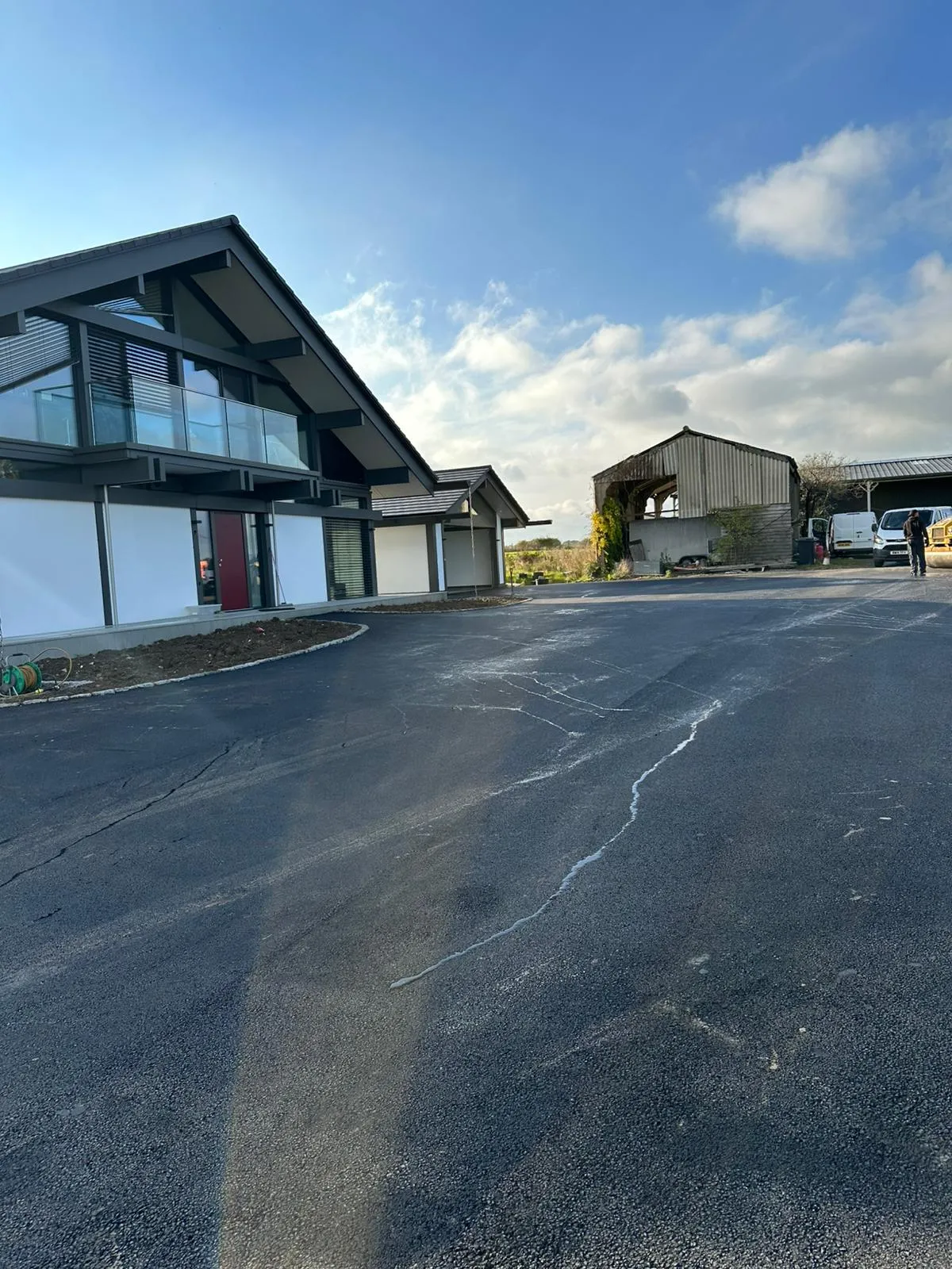 An empty parking lot with a building in the background.